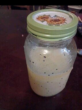 Homemade vanilla sugar body scrub in glitter mason jar